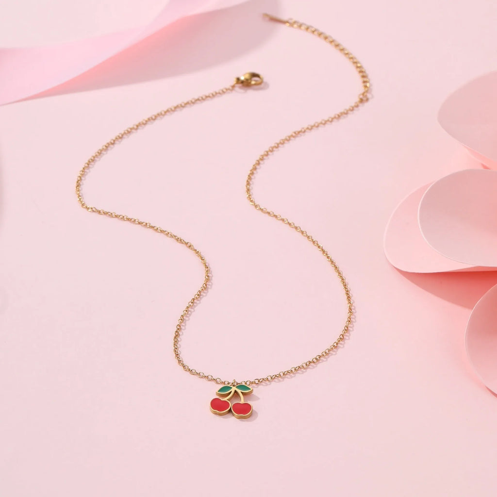 Cherry jewellery set showing necklace, bracelet, earrings, and ring with stainless steel construction and cherry motifs