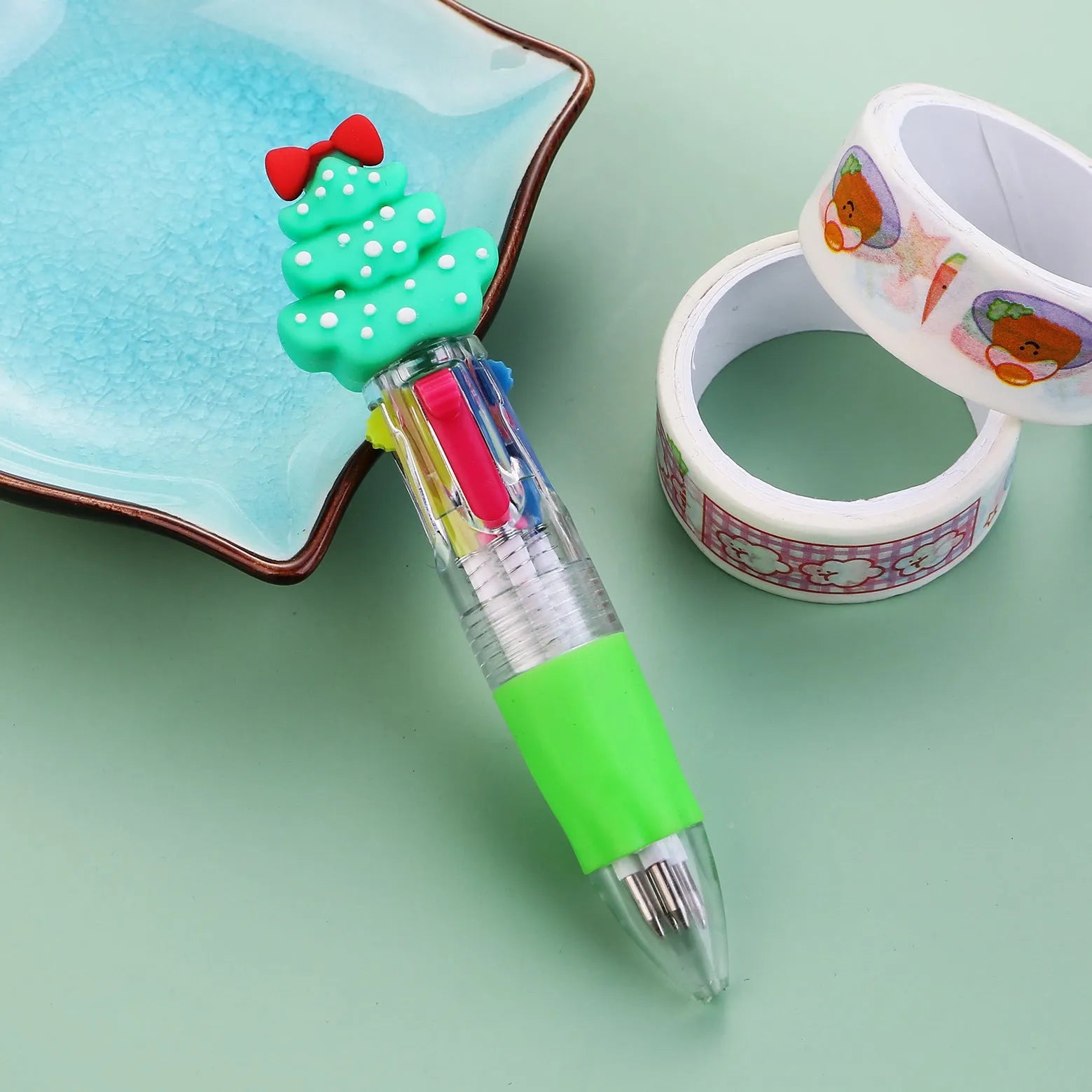 Christmas mini four-colour press-action ballpoint pen with festive designs measuring 11 cm.