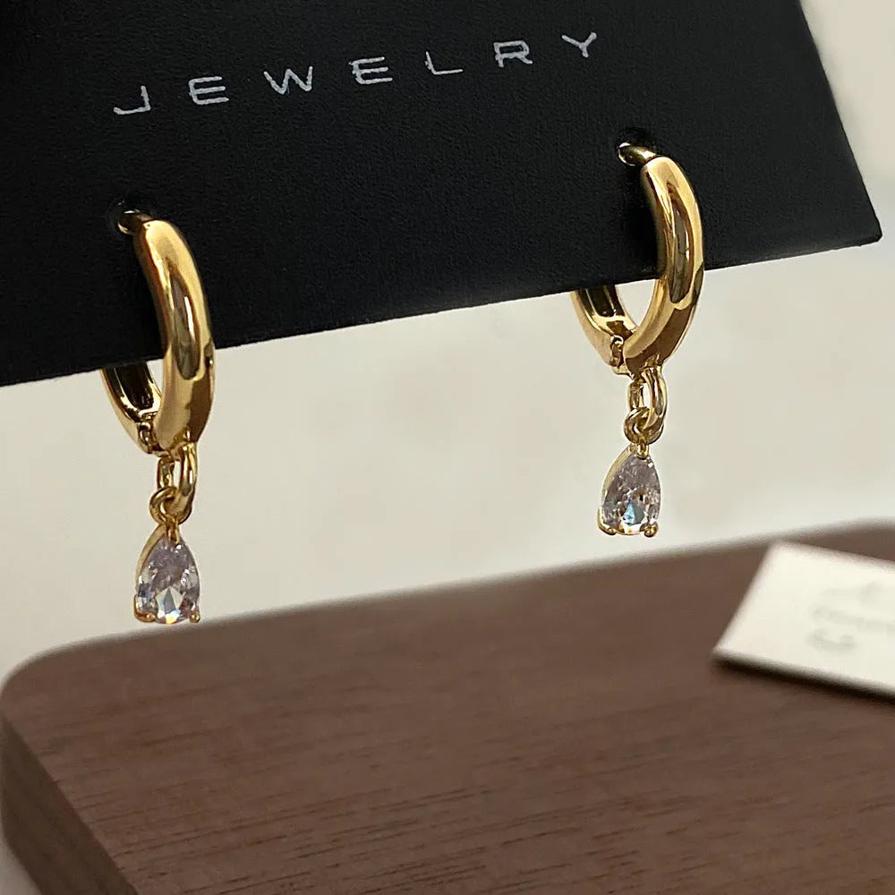 Women's three-piece zircon jewellery set showing necklace, anklet and earrings with geometric meteor shower design