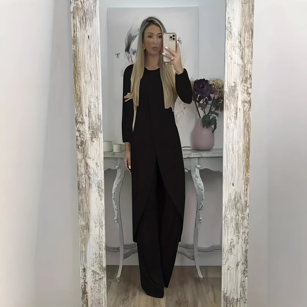 Women's black polyester two-piece lounge set with long sleeve top and loose trousers on a hanger.
