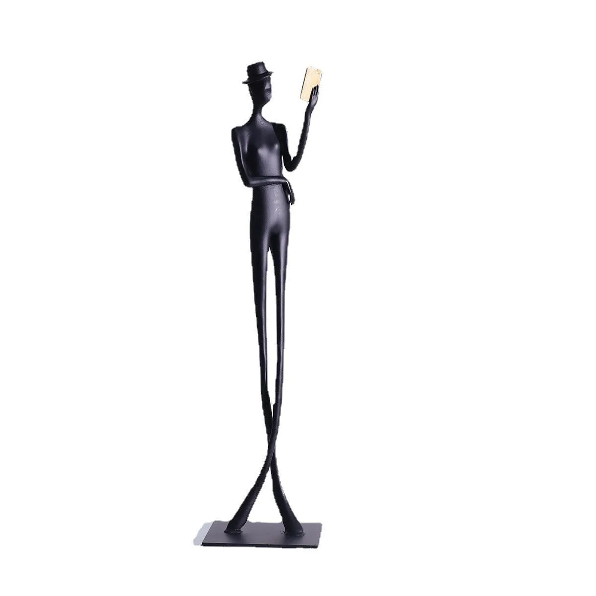 Black cast aluminium sculpture of a reading woman on a desktop, 51 cm tall.