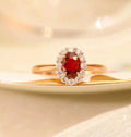 Sterling silver ring with gold pigeon design and red gemstone in floral pattern
