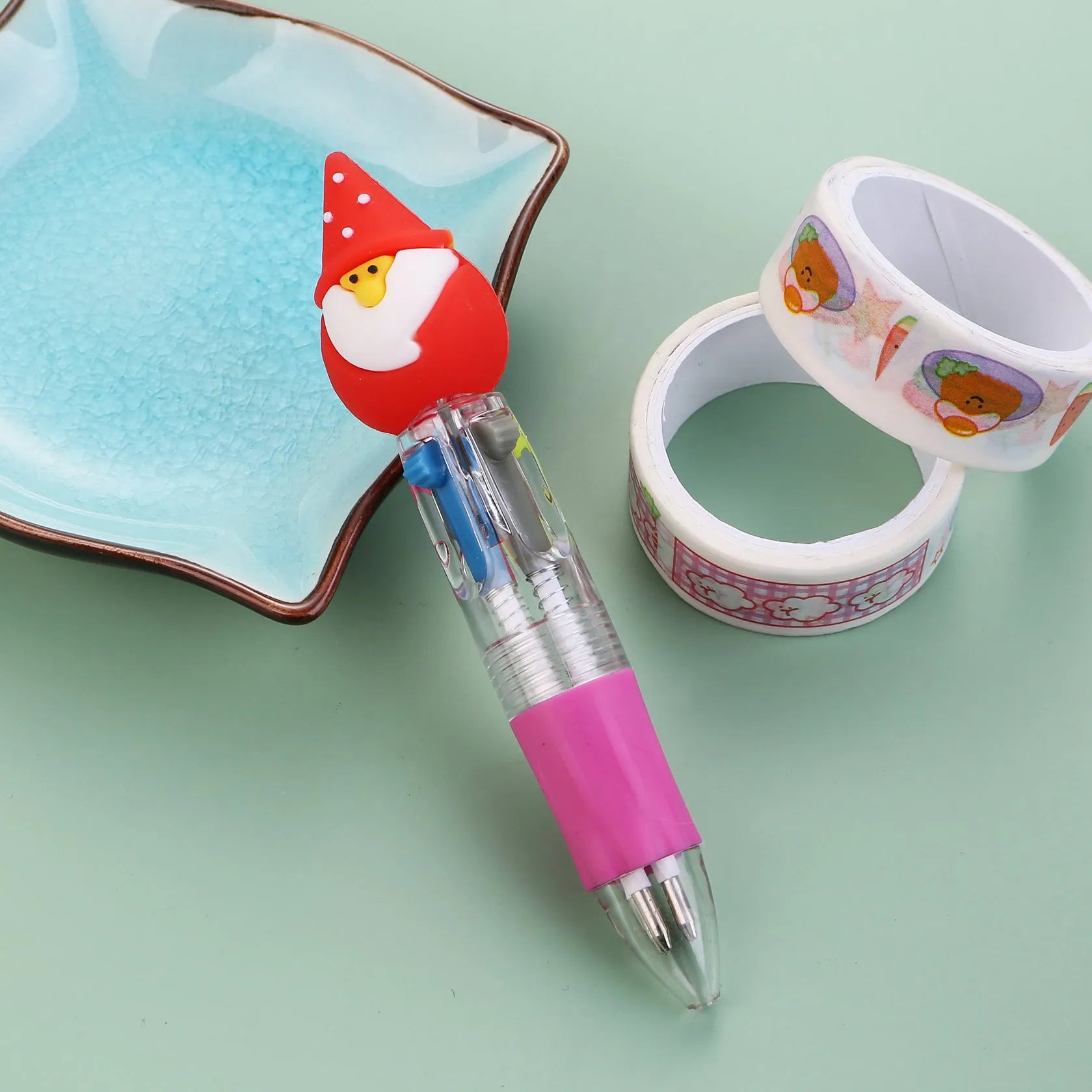 Christmas mini four-colour press-action ballpoint pen with festive designs measuring 11 cm.