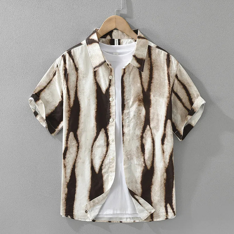 A retro-style black and white striped short sleeve shirt with a loose, cardigan fit.