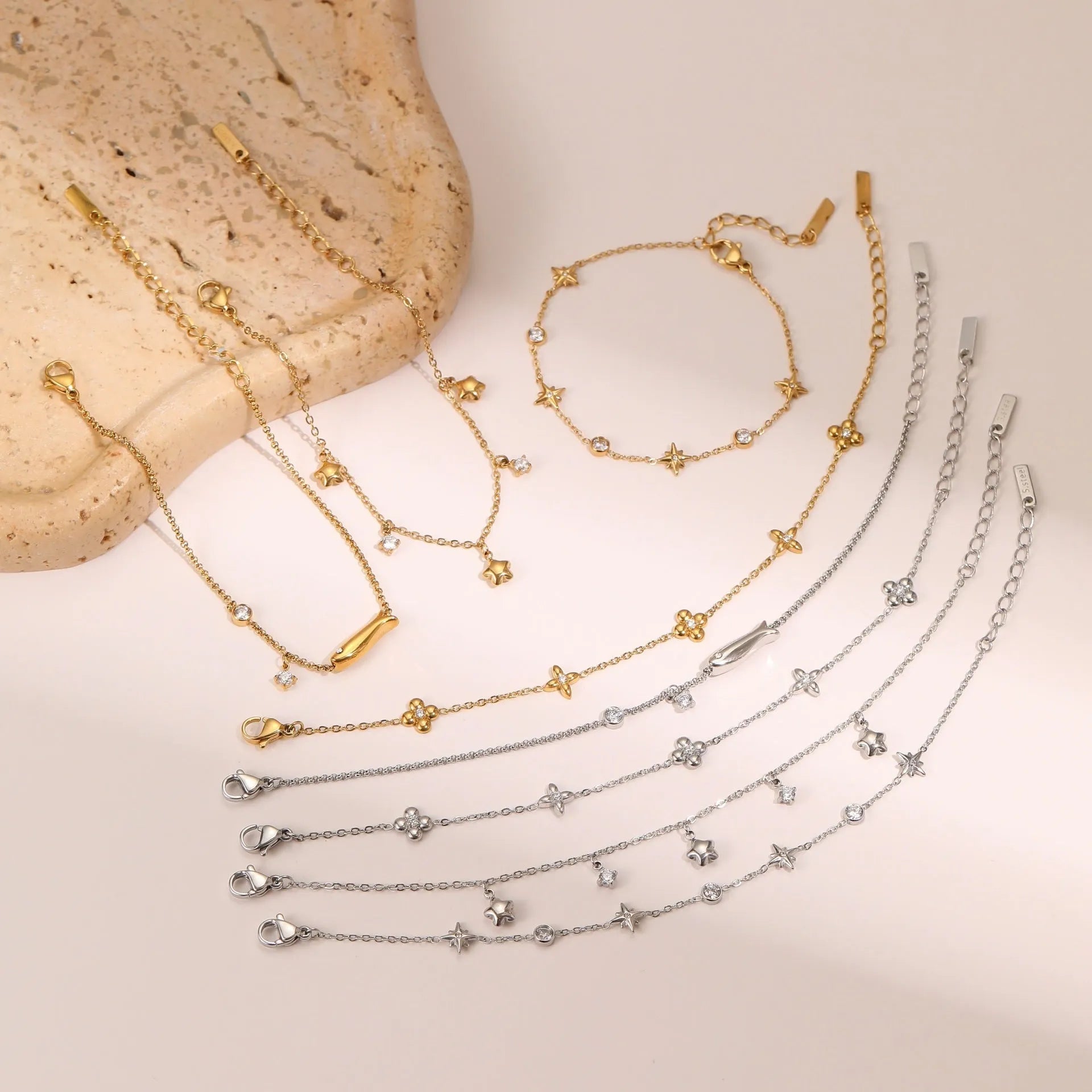 Gold plated star pendant bracelet on stainless steel chain with geometric hexagonal design