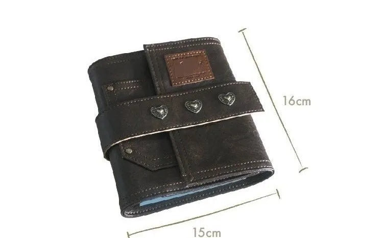 Brown A7 leather buckle notebook with loose-leaf binding on wooden surface