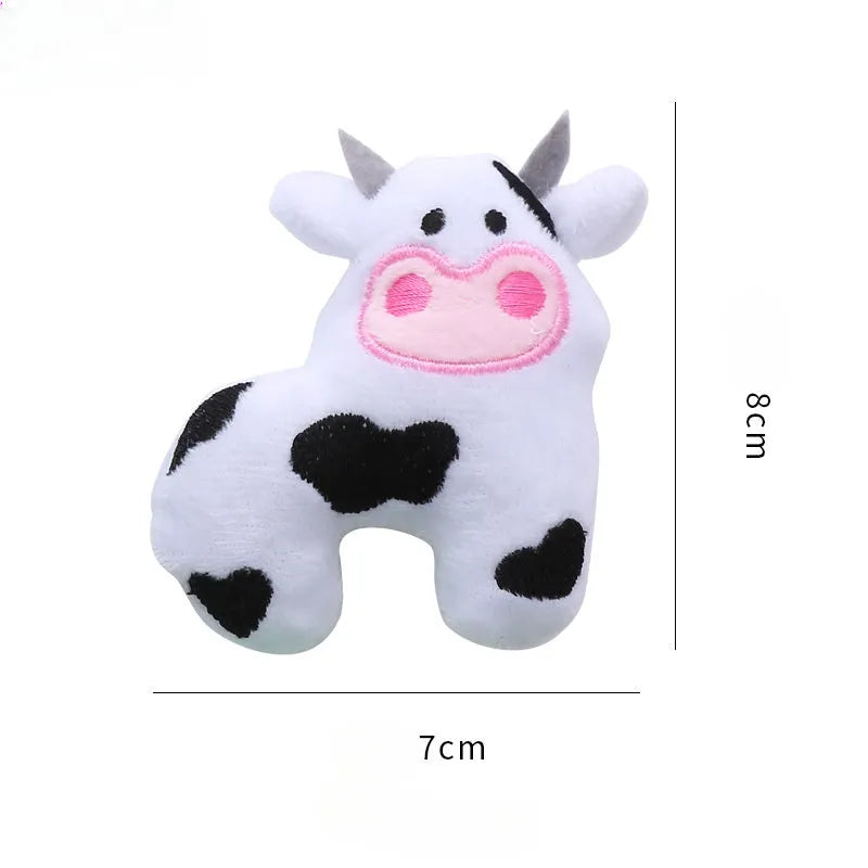 Plush green parrot-shaped cat toy with catnip, shown next to cow and crocodile versions.