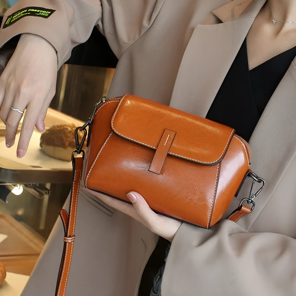 Brown genuine oil wax leather women's messenger bag with shell shape and single cross-body strap