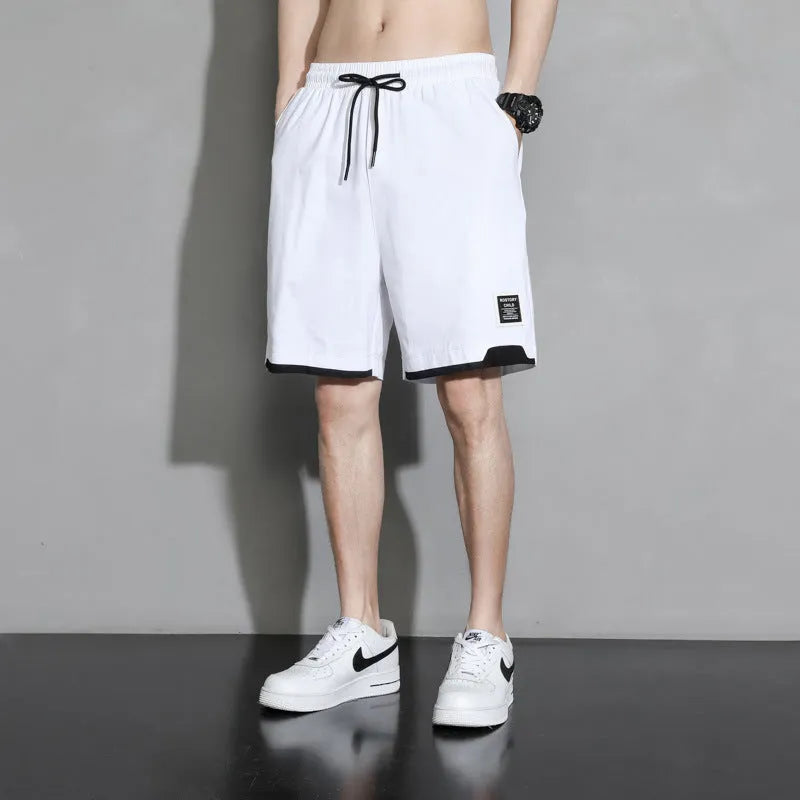 Boys' black cotton shorts in a plus size on a hanger