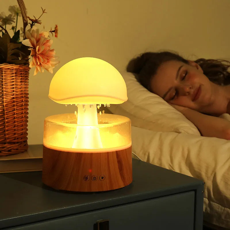 White cloud-shaped ultrasonic humidifier and aroma diffuser with simulated rain drops and coloured light.