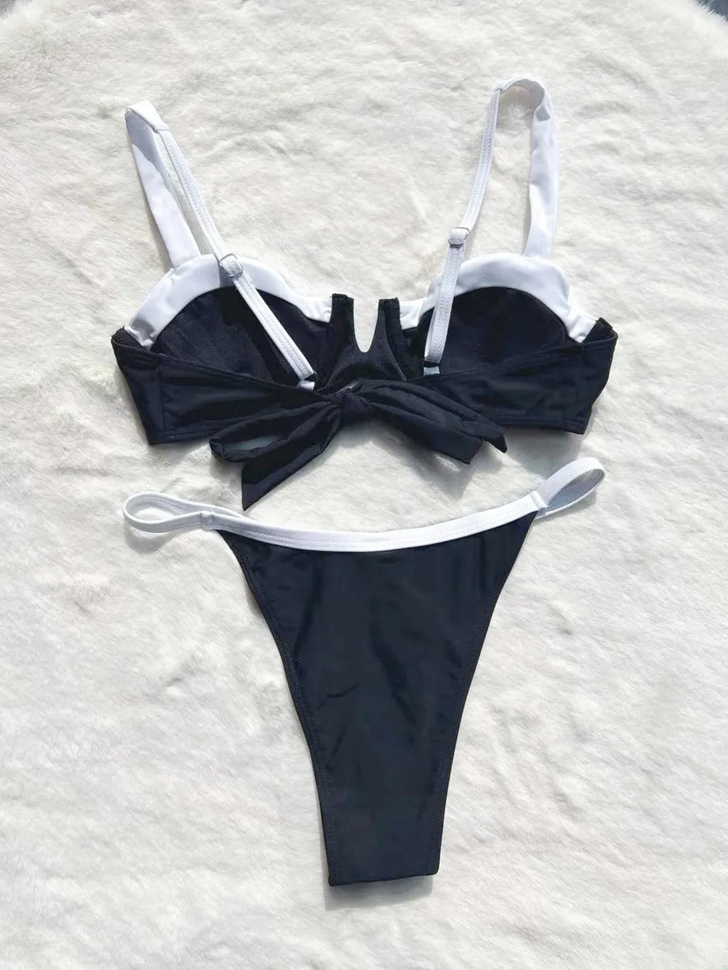 Black women's low waist bikini with stitching split detail on briefs, shown from front.