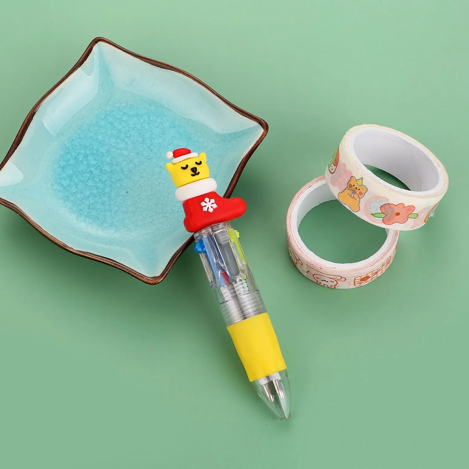 Christmas mini four-colour press-action ballpoint pen with festive designs measuring 11 cm.