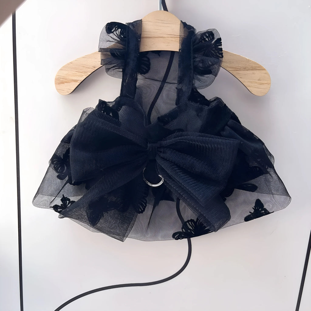 Black polyester tulle princess skirt for a small dog or cat on a hanger.