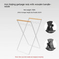 Black folding iron trash storage rack with wooden handle holding rubbish bag