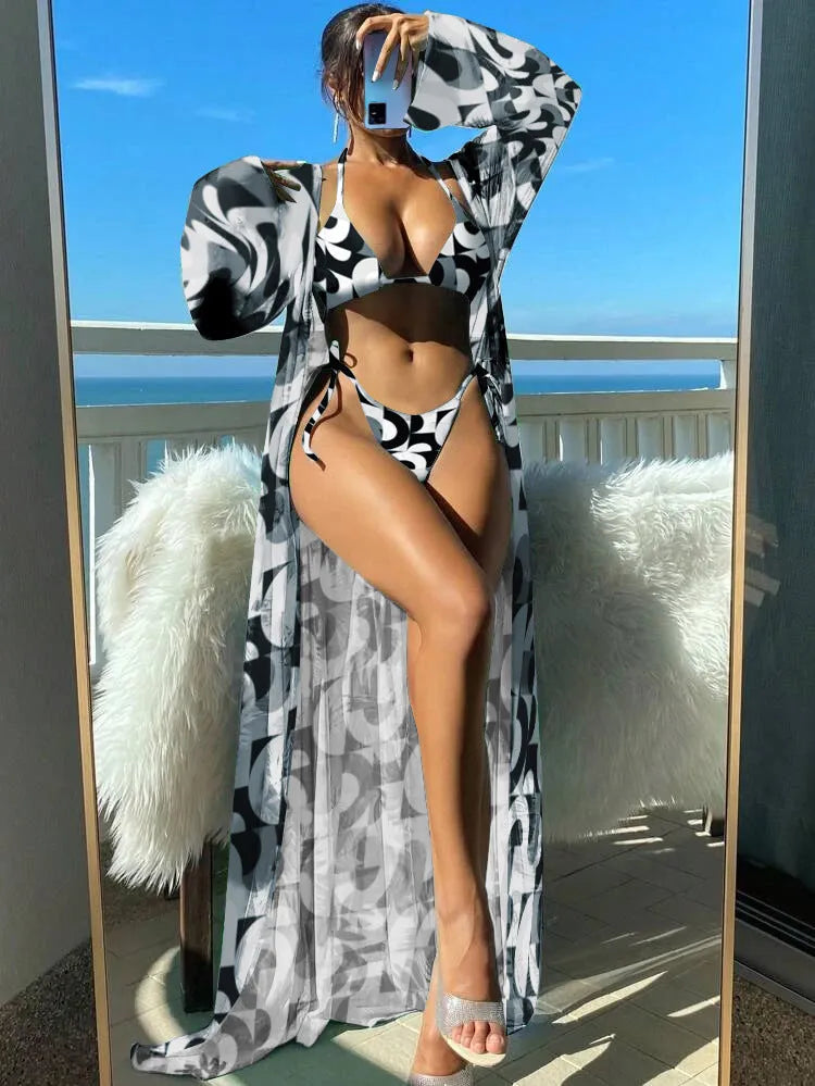 Women's floral pattern bikini set with long sleeve cover-up and banded briefs on a mannequin