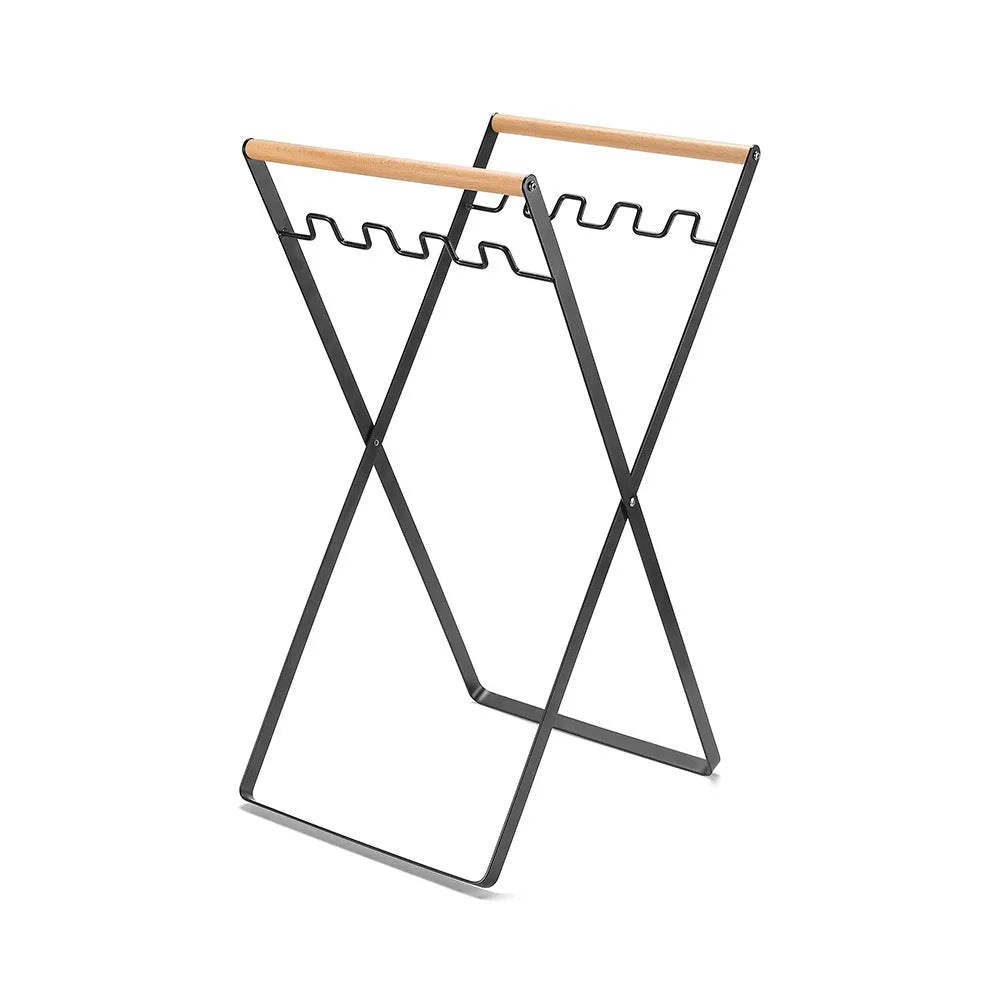 Black folding iron trash storage rack with wooden handle holding rubbish bag