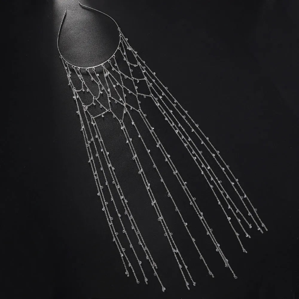 Gold and silver mesh headband with rhinestones and a decorative tassel on an adjustable band.