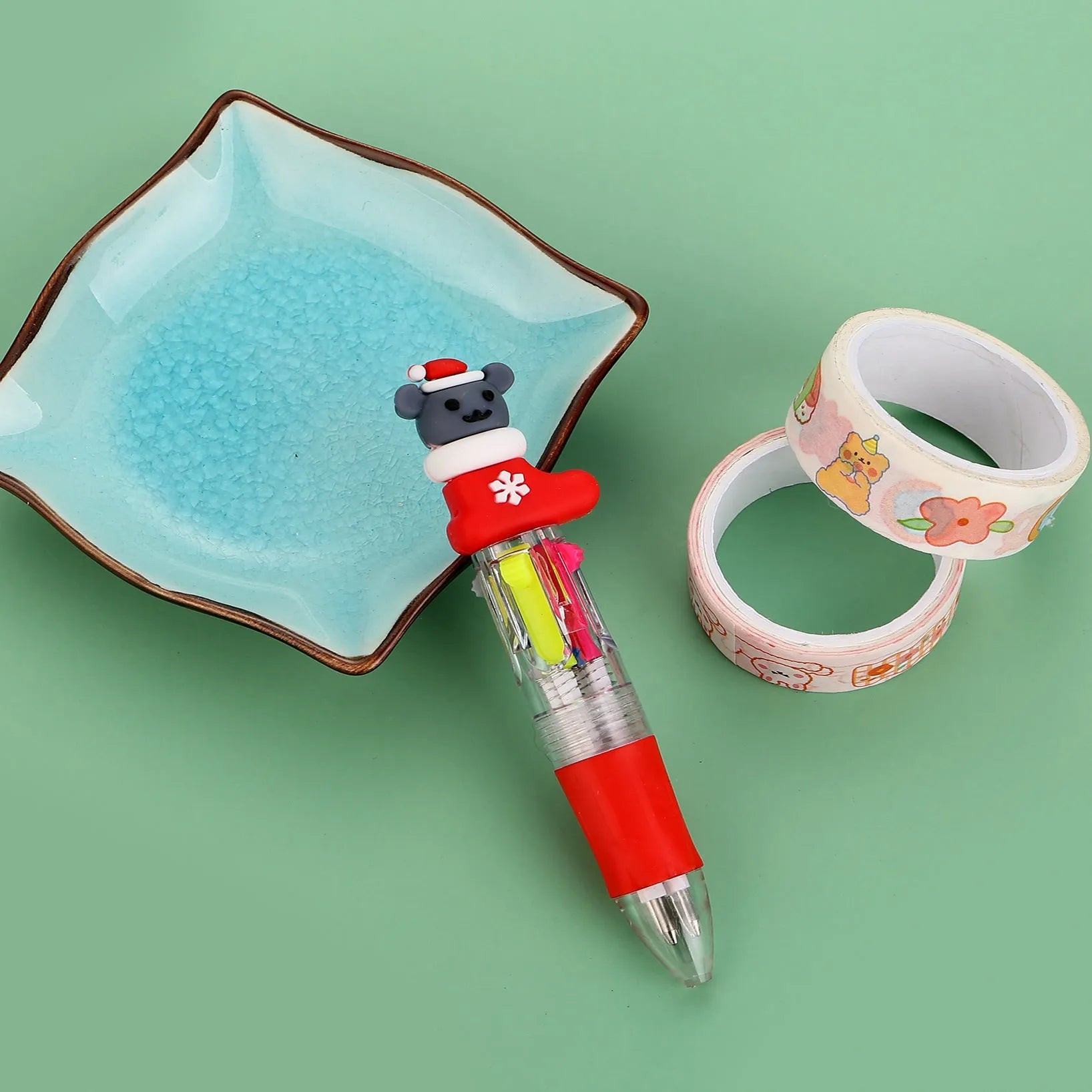 Christmas mini four-colour press-action ballpoint pen with festive designs measuring 11 cm.