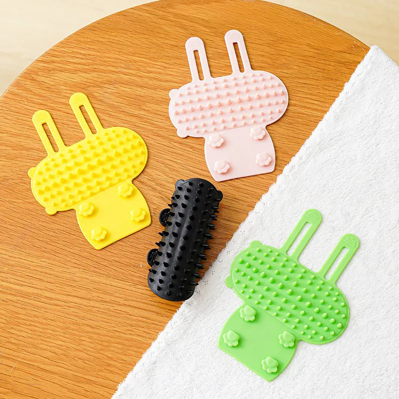 Silicone cat grooming massage comb with rounded teeth and adjustable mounting strap in assorted colours