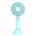 Blue handheld USB mini fan with three-speed buttons and oscillation function on a desk.