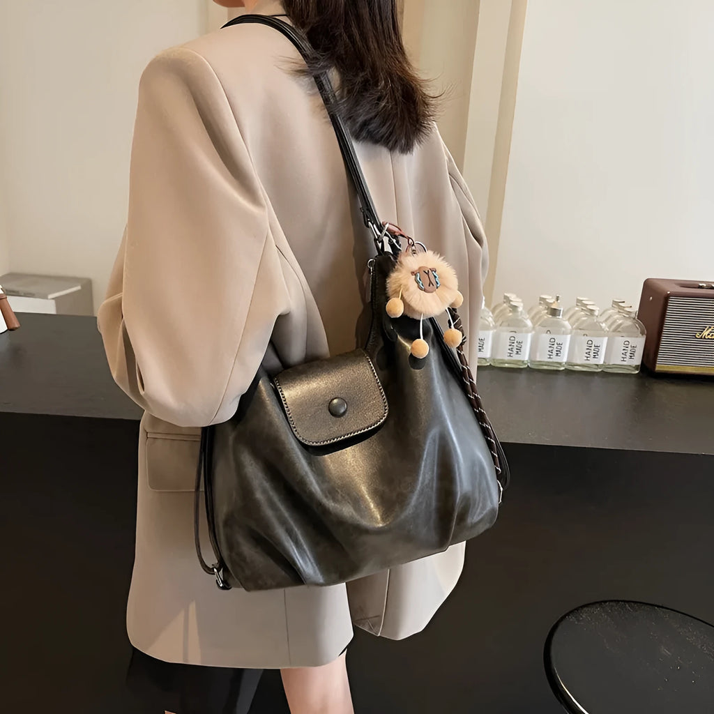 Textured PU leather commuter backpack with single shoulder strap and internal mobile phone pocket