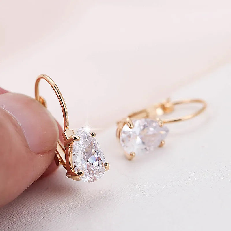Drop-shaped women's metal earrings with gemstones in gold or platinum colour.