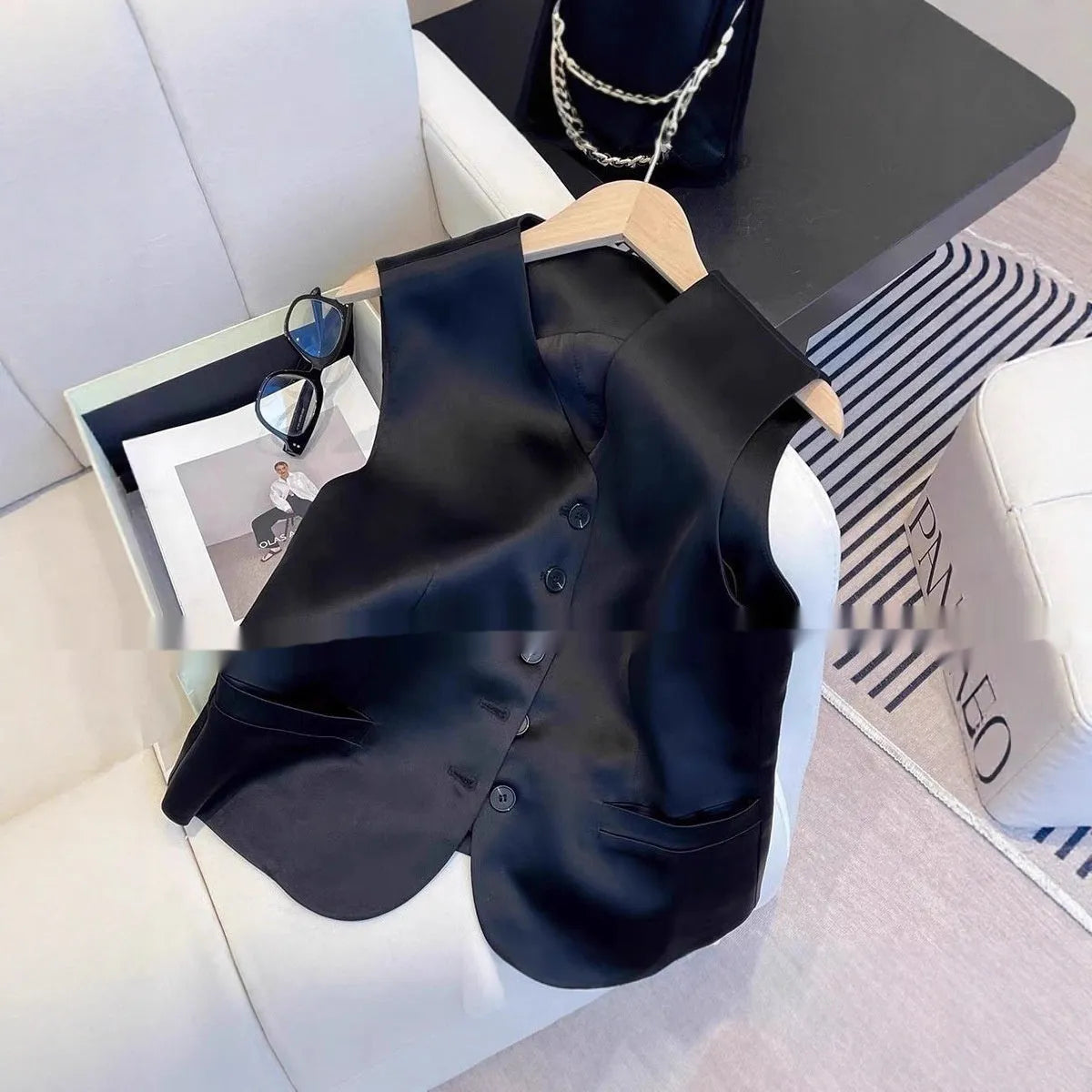 Black satin sleeveless vest for women with loose fit design and splicing detail