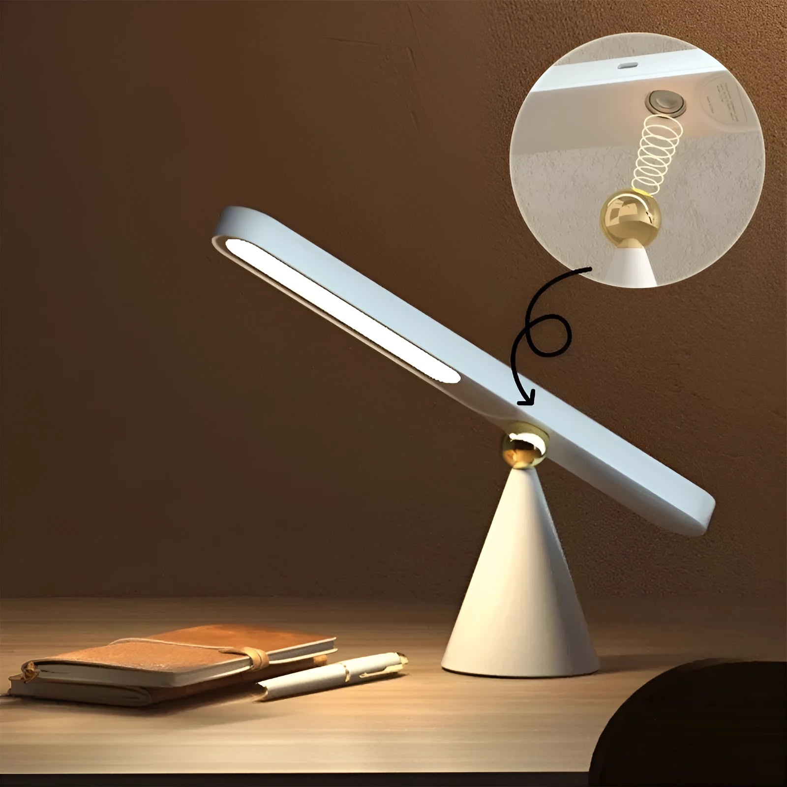 Geometric design table lamp with magnetic base on desk next to USB cable