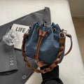 Blue one-shoulder cross body bucket bag with messenger style design and synthetic leather lining