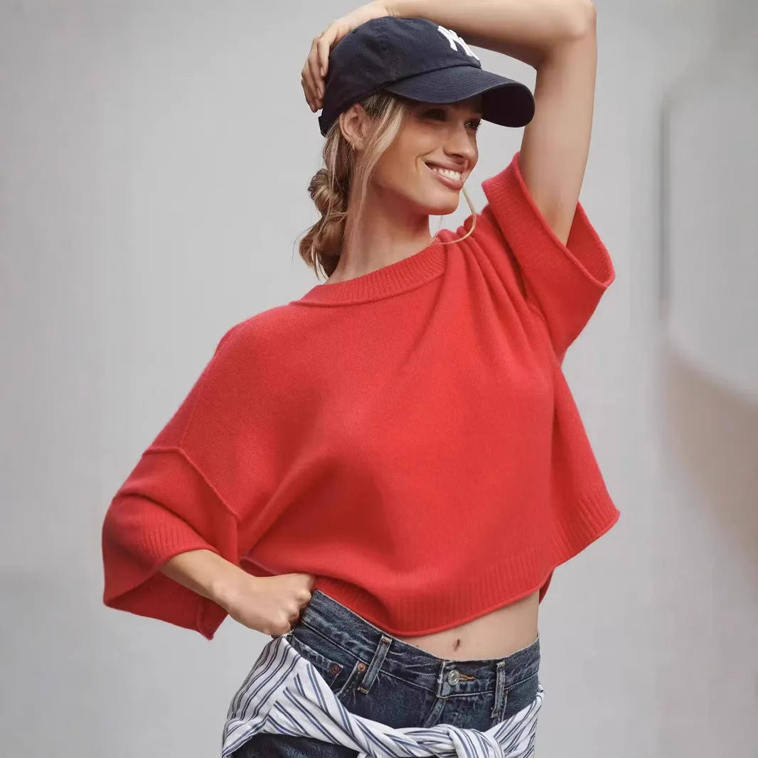 Red cropped t-shirt on a hanger, showing midriff length and regular sleeves.