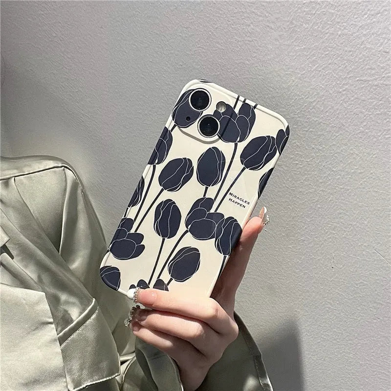 Black silicone iPhone case with a tulip flower design on the back.
