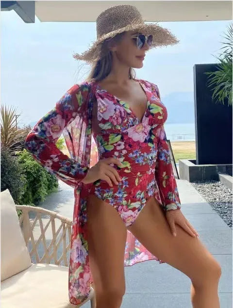 Women's floral patterned tight bikini three-piece swimsuit set with a cover-up coat.