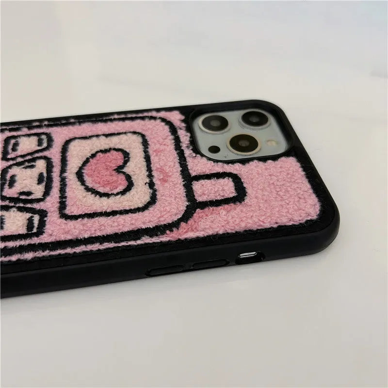 Pink TPU iPhone case with a textured towel-embroidered back cover, shown fitting an iPhone.