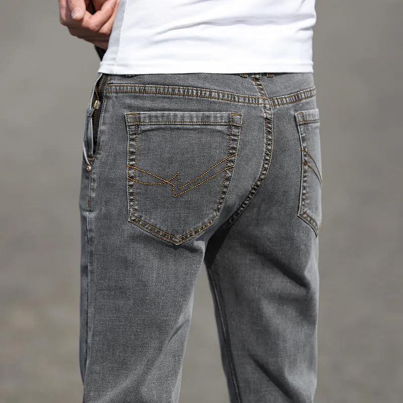 Men's autumn smoky grey straight leg jeans with high elasticity and low waist design