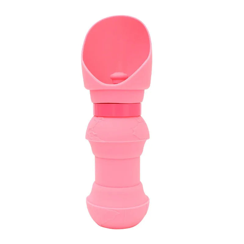 Collapsed and unfolded pink silicone folding water bowl for pets on a table.