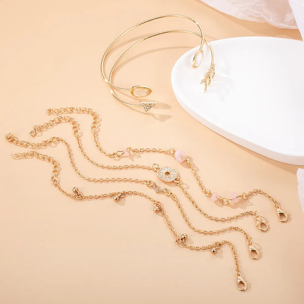Gold zinc alloy women's bracelet set with arrow, water drop, and V-shaped pendants