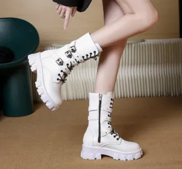 Women's black mid-calf boots with metal buckle straps and a side zipper on a white background.