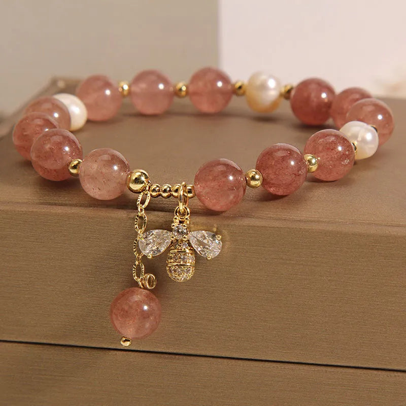 Freshwater pearl and strawberry quartz bracelet with zircon accents on wrist