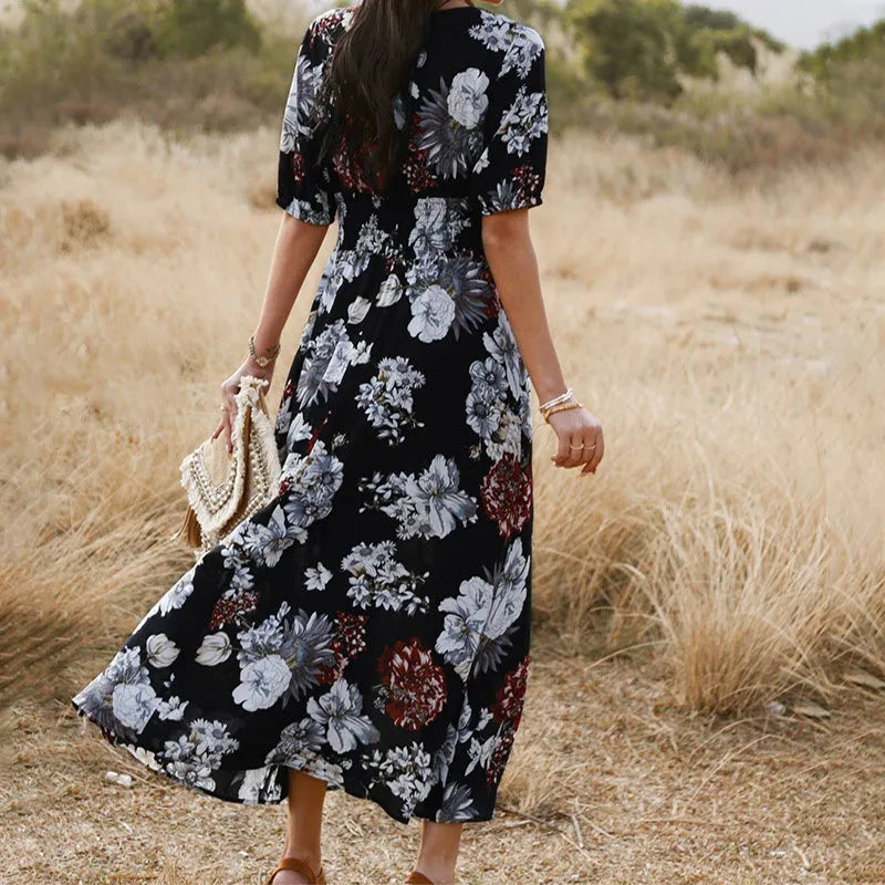 Yellow floral print women's dress with v-neck, short sleeves, elastic high waist, and a large hemline midi skirt.