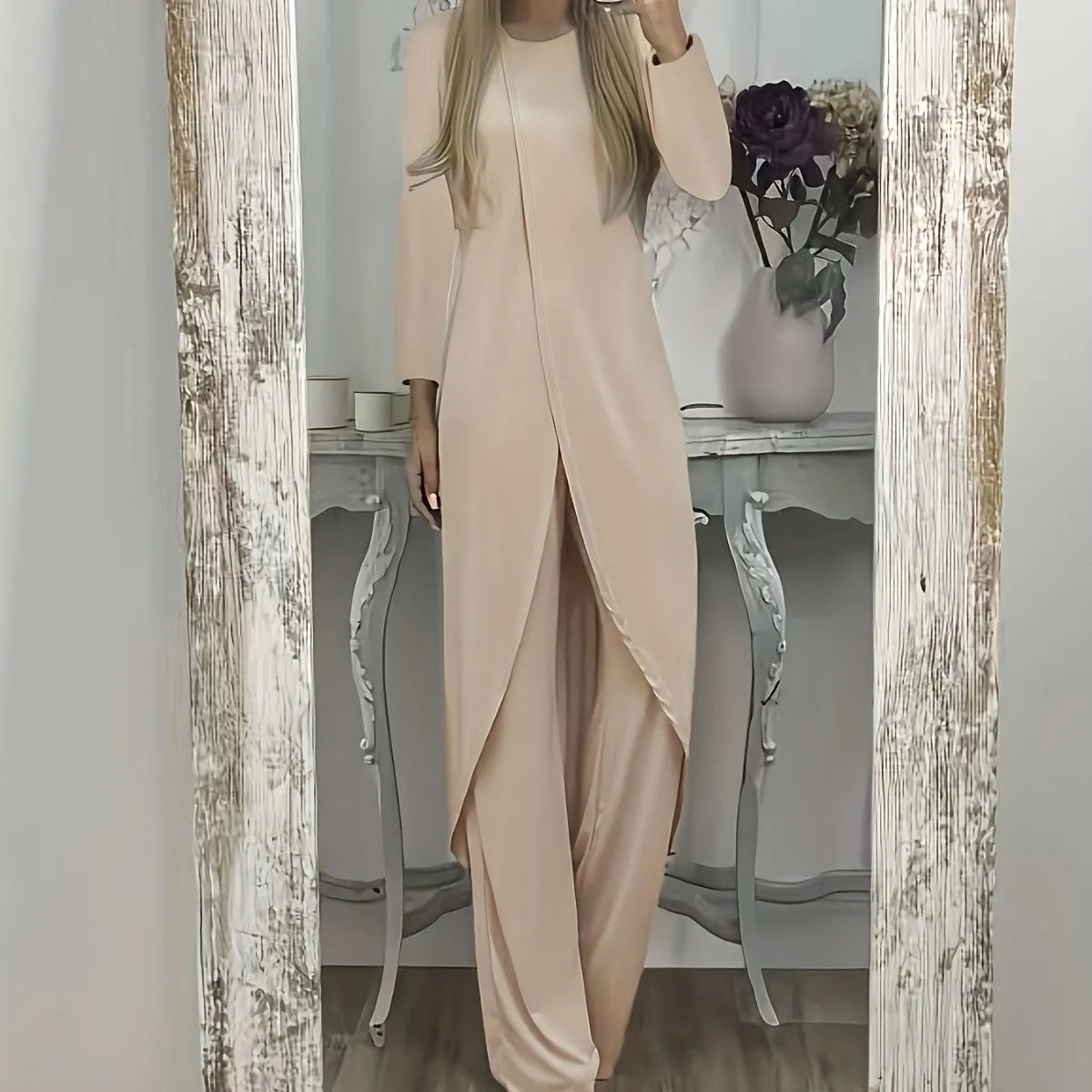 Women's black polyester two-piece lounge set with long sleeve top and loose trousers on a hanger.