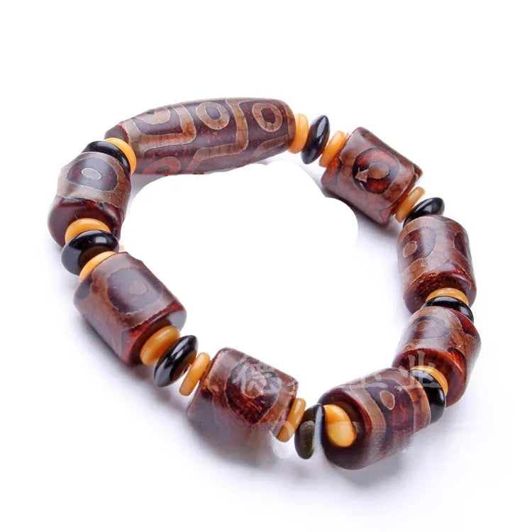 Distressed agate Tibet bead bracelet with three-eye motifs and multiple traditional bead styles on wrist