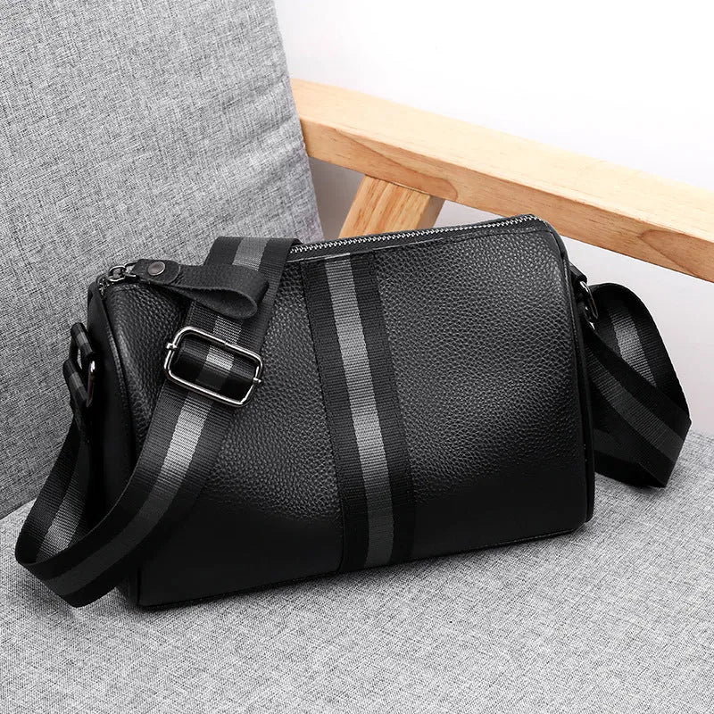 Black genuine leather one-shoulder crossbody bag showing 24x16x13cm dimensions and polyester lining interior