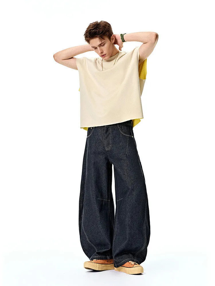 Men's wide leg denim trousers in original cow colour showing relaxed fit and mid waist construction