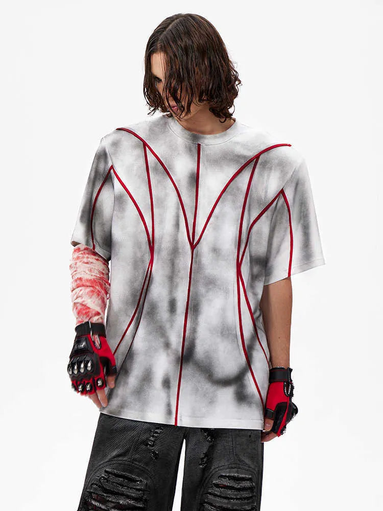 Short sleeve T-shirt with padded shoulders and textured line patchwork on a round neck.