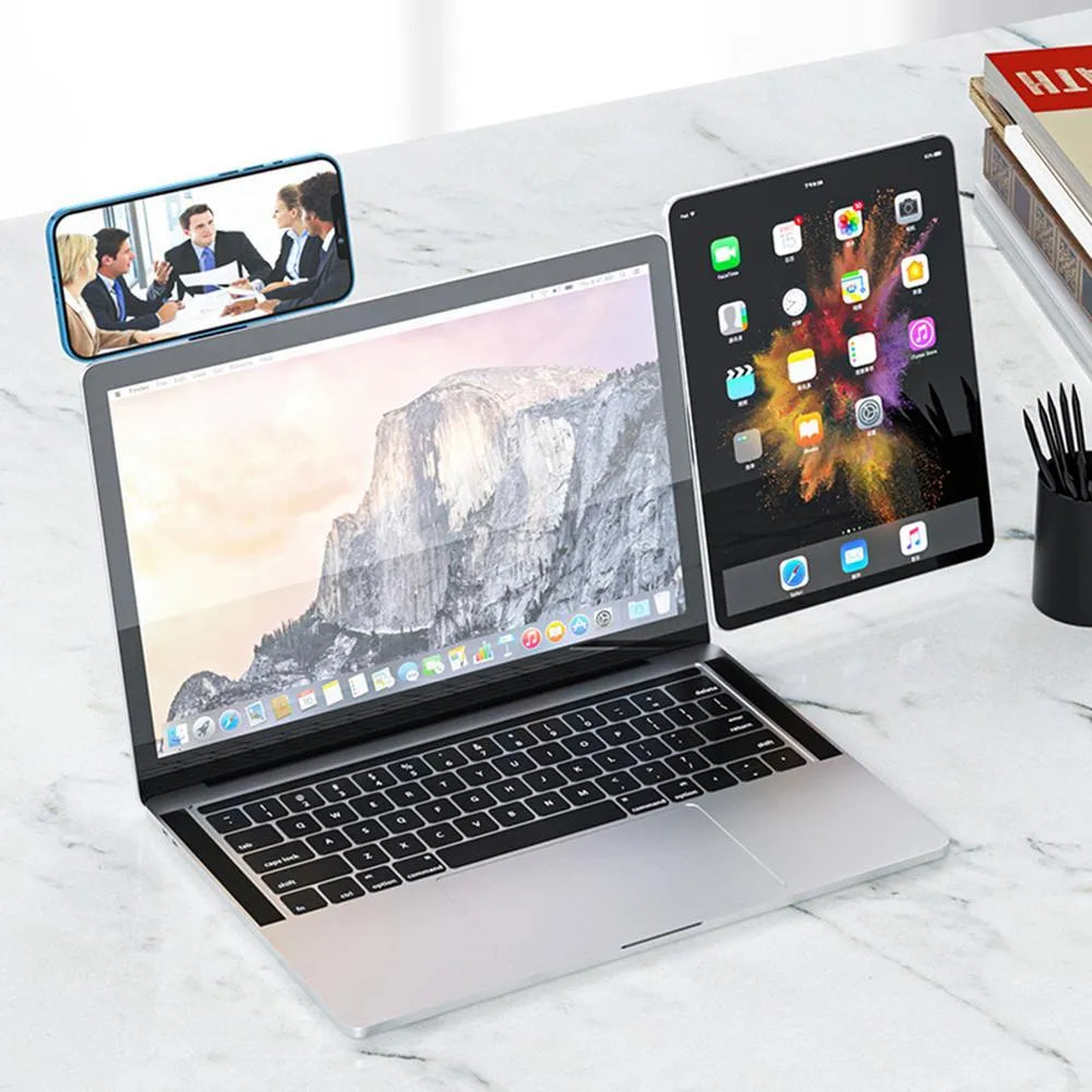 Black aluminium laptop phone holder with magnetic mount attached to a monitor showing a smartphone in place