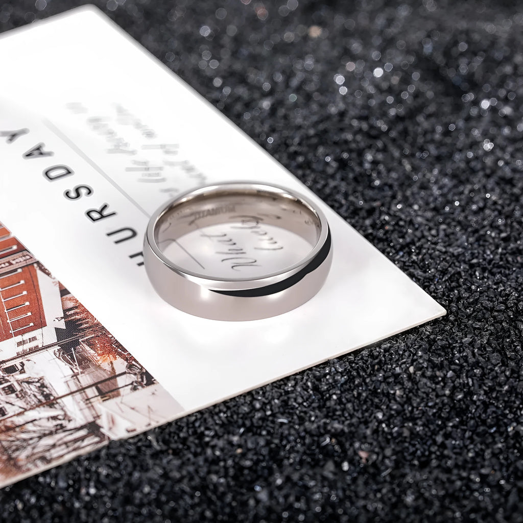 Silver titanium steel unisex ring shown in multiple width options on a size chart.
