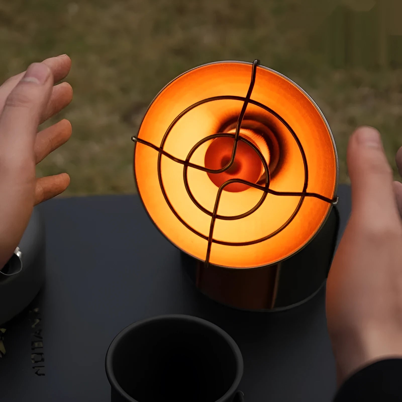 Black and orange portable heating stove for outdoor camping with automatic ignition