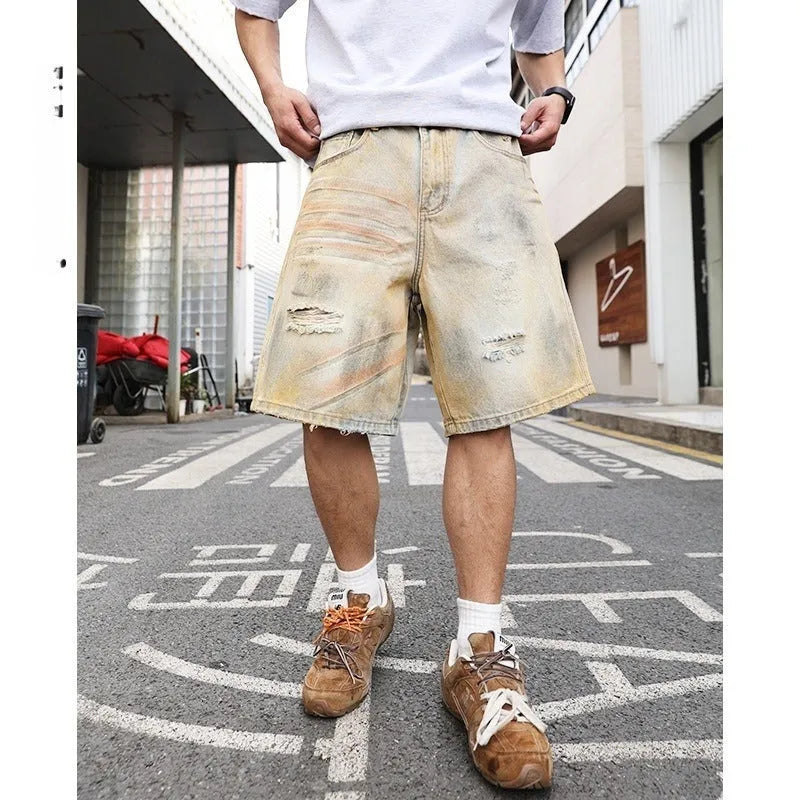 Men's light blue washed denim shorts with ripped details and a straight-leg cut