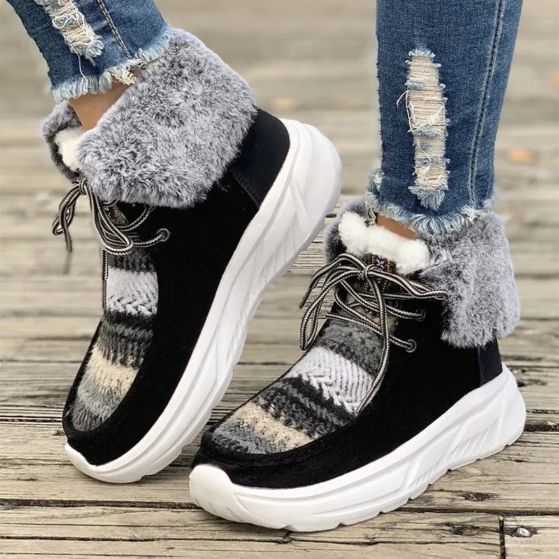 Women's beige lace-up snow boots with suede upper and fur lining on a white background.