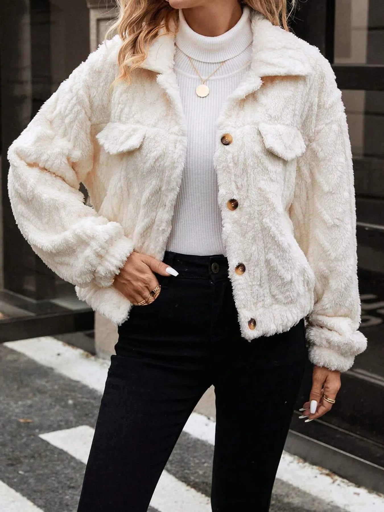 Ivory white women's plush button cardigan with regular sleeves on hanger